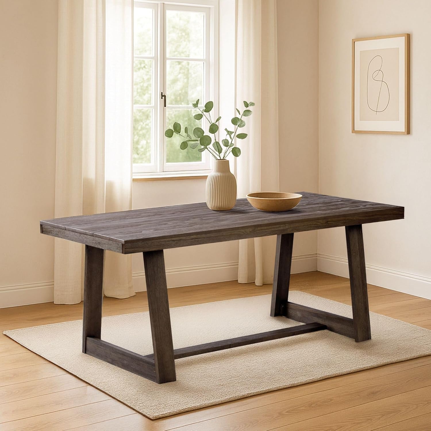 Dark charcoal-finished dining table centered on a neutral rug with a vase and bowl on top