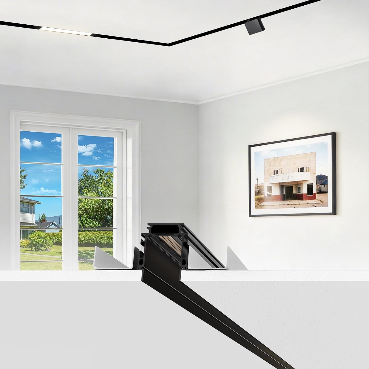 Cross-section illustration of a recessed black track installed in a ceiling corner above a bright room