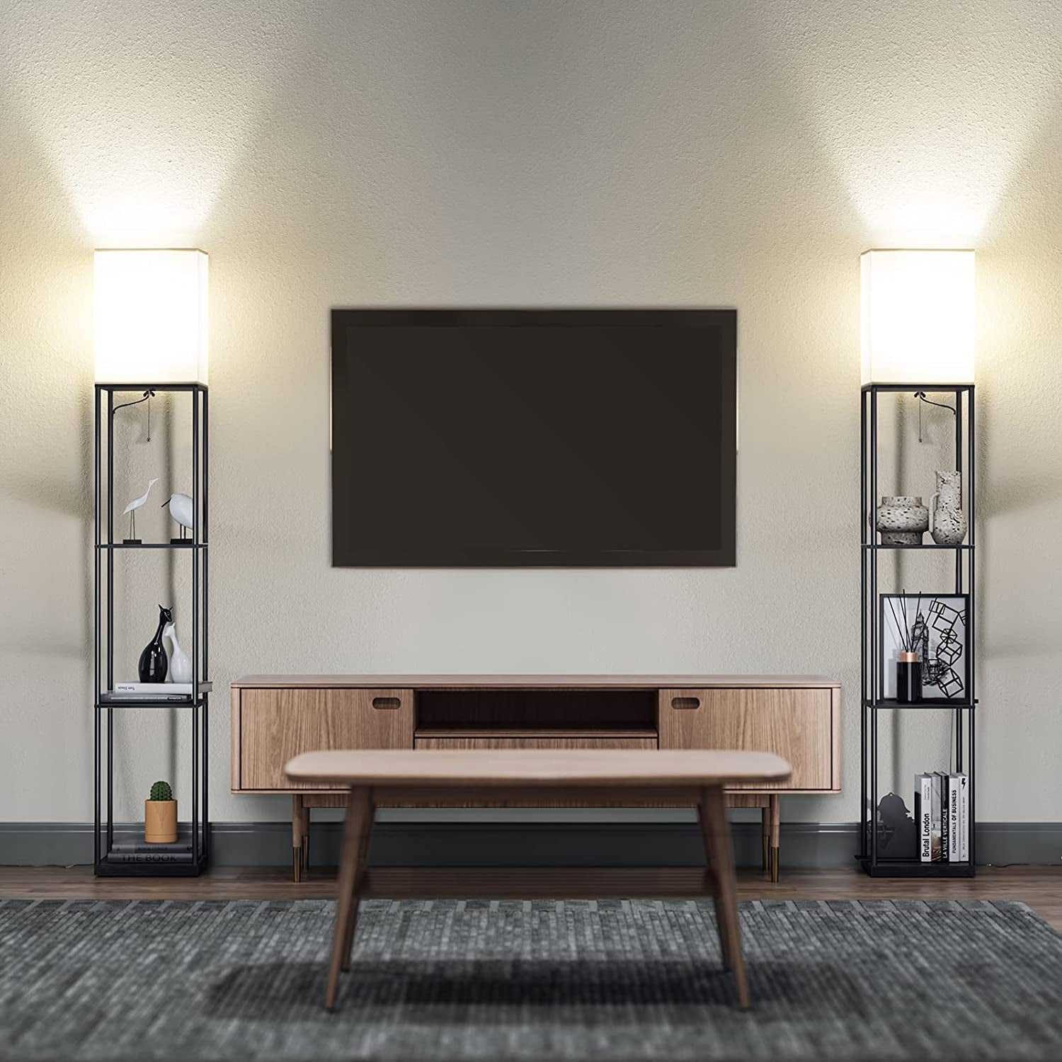 Two identical black shelving floor lamps flanking a wall-mounted TV in a living room.