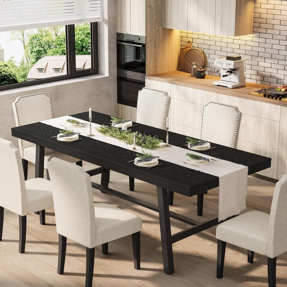 Black-finish extendable table with a white runner and dining place settings, surrounded by cream upholstered chairs.