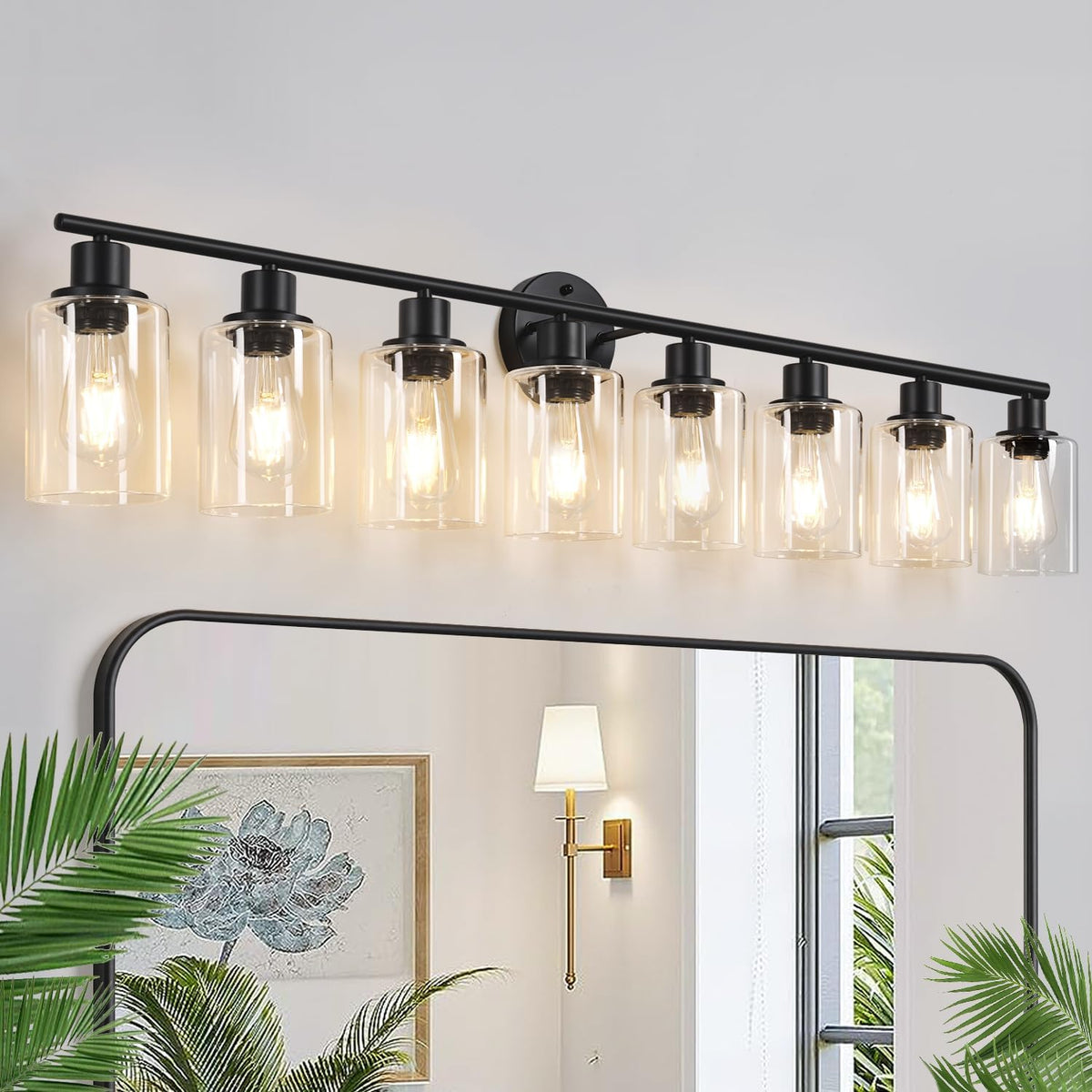 Long black vanity fixture with seven clear glass cylindrical shades mounted over a mirror.