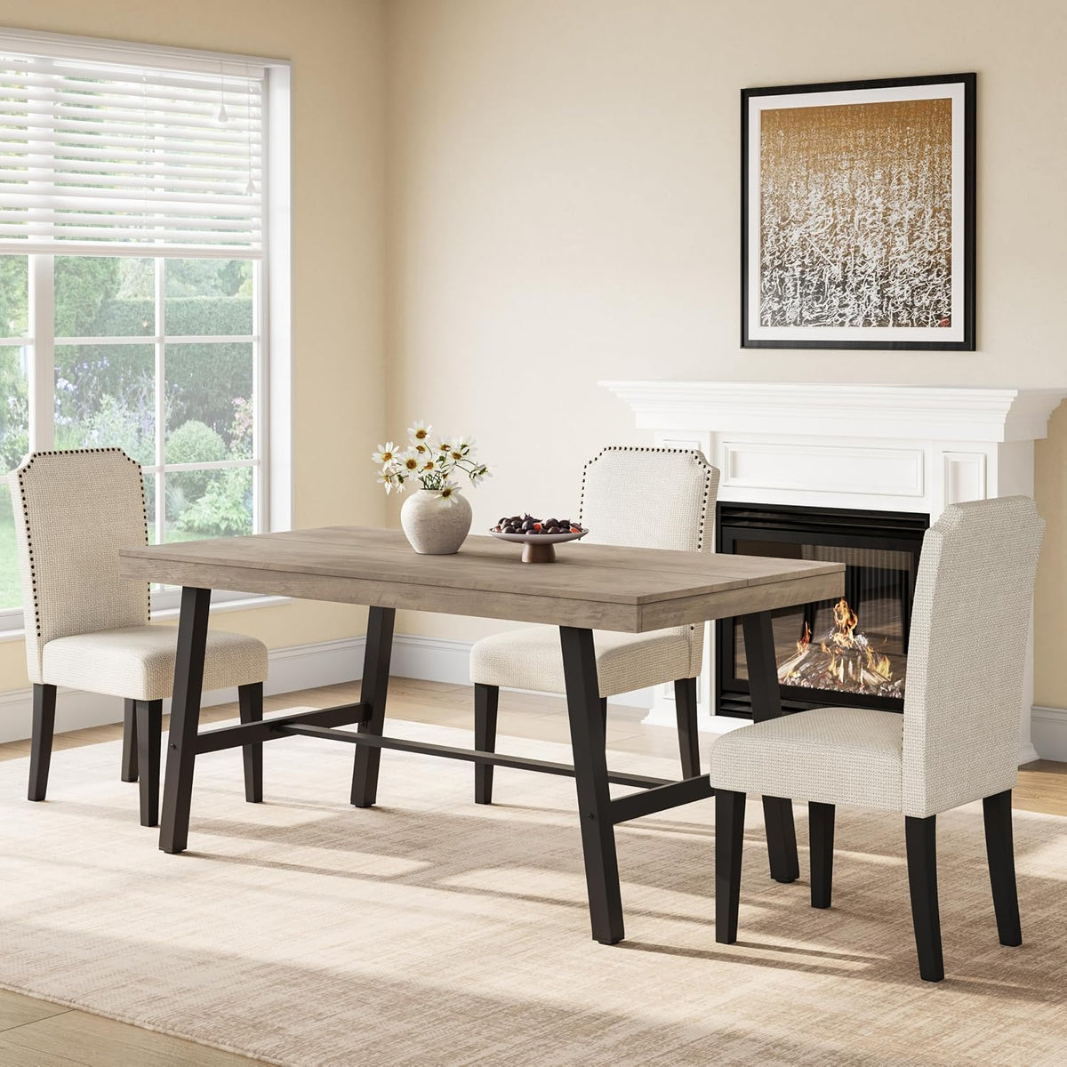 Gray-weathered wood tabletop on a rectangular table with black metal legs beside a fireplace and chairs.