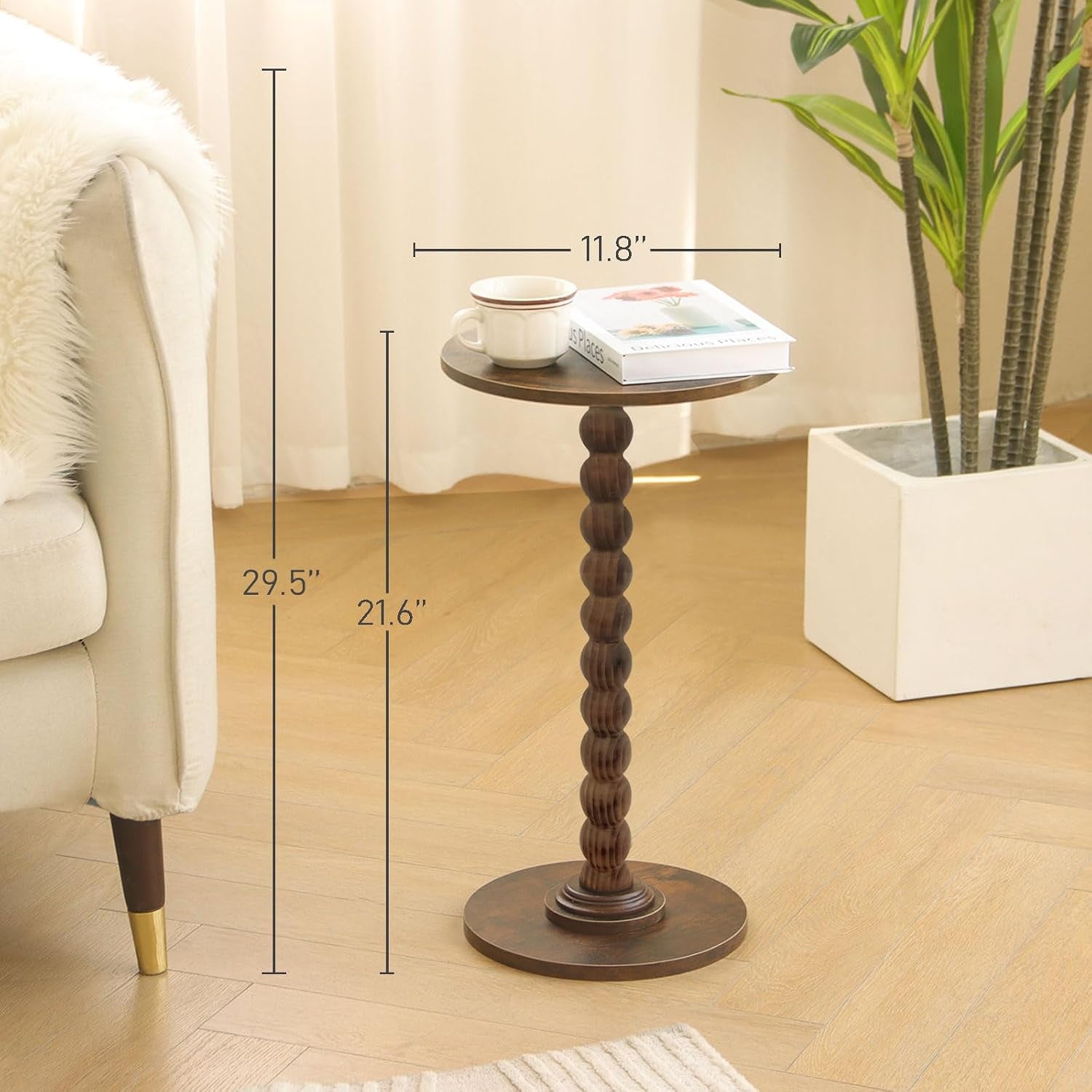 Round side table in room setting with cup and book, dimensions overlay showing 11.8" diameter and 21.6" height
