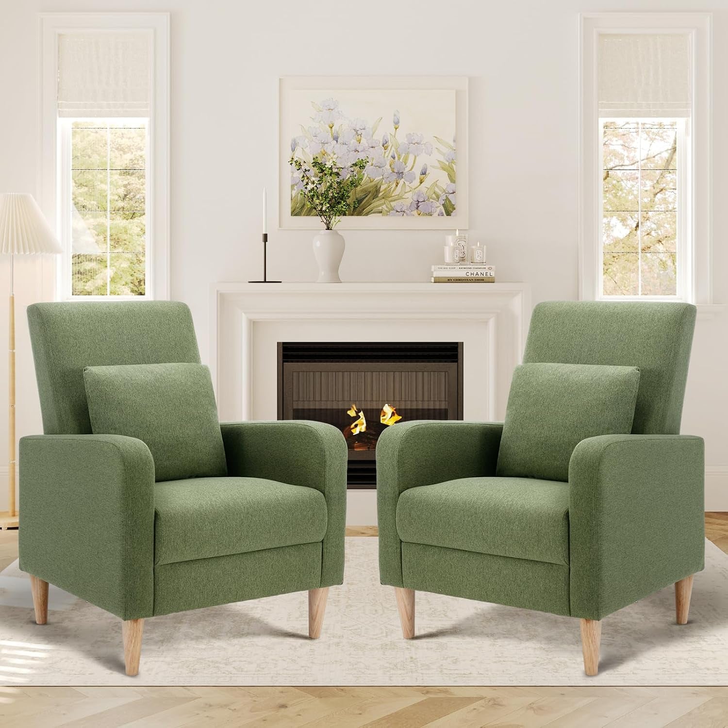 Two green high-back accent chairs with removable pillows facing slightly inward in a living room.