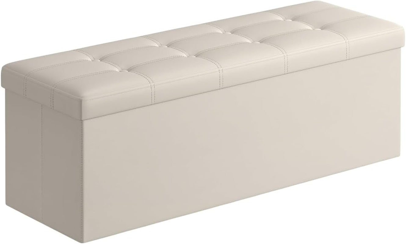 Rectangular tufted storage ottoman bench in light beige shown at an angled three-quarter view