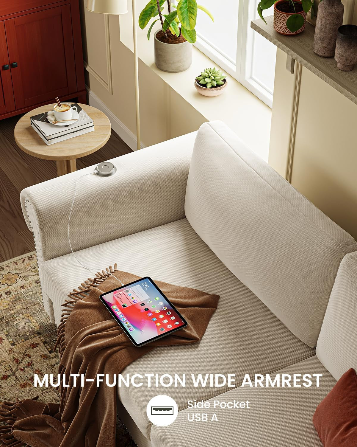 Close-up of beige sofa armrest showing built-in USB charger and side pocket with tablet on seat