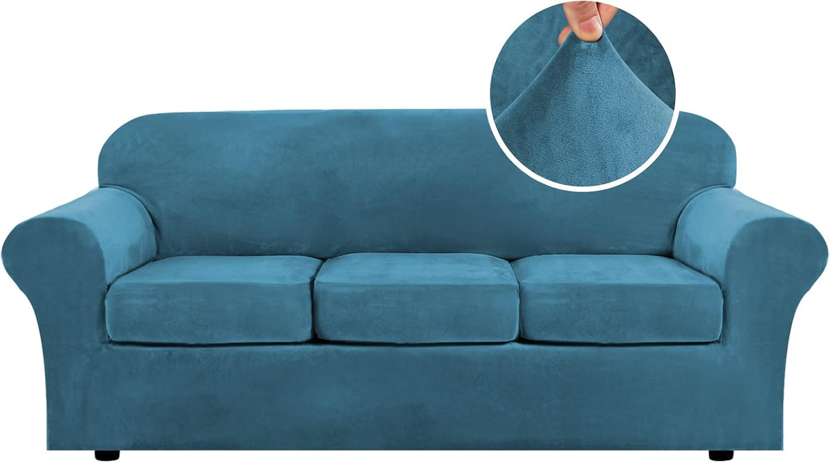 Straight-on view of a three-seat sofa in bright blue velvet stretch cover showing three seat cushions and a fabric pinch