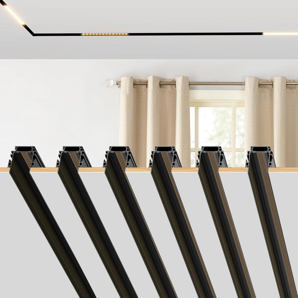 Row of multiple angled black recessed rail profiles displayed against a light background beneath a window and curtain.