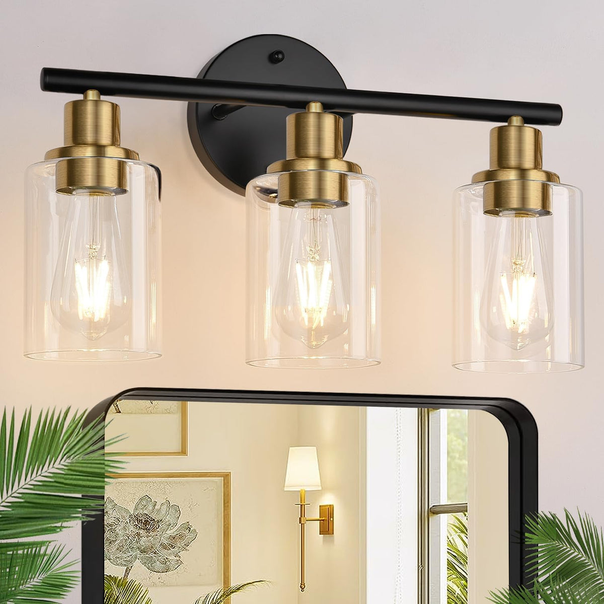 Tight view of three clear-glass shades and brass sockets on a black horizontal bar mounted to the wall