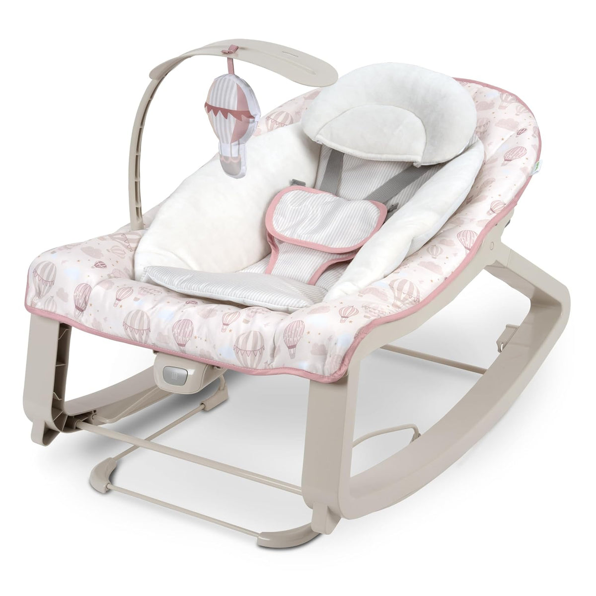 Three-quarter view of a pink hot-air‑balloon printed baby bouncer with plush head support and hanging hot-air toy.