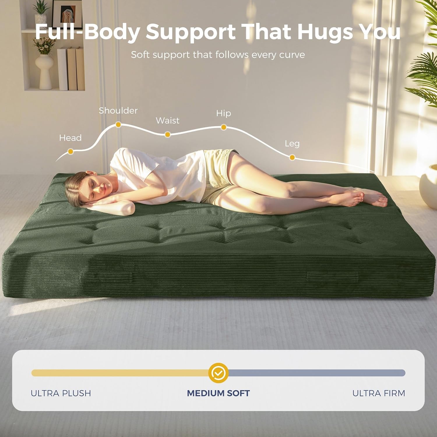 Woman lying on a dark green foldable futon mattress on a metal frame demonstrating full-body support and medium-soft feel