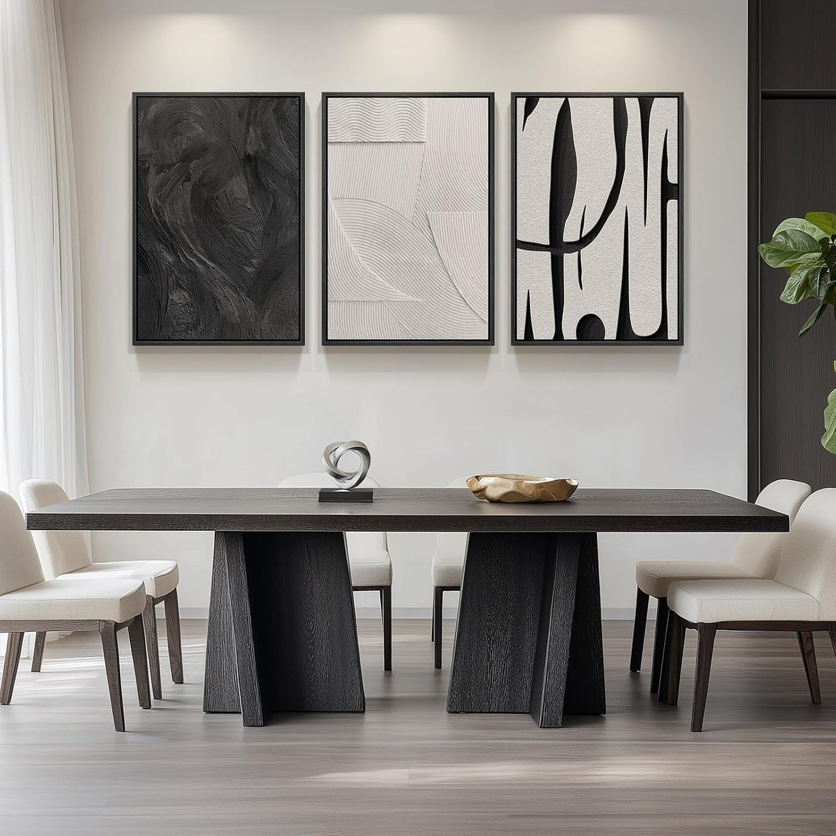 Dining room scene with a three-piece set of black-framed abstract prints hung above a dark wood table.