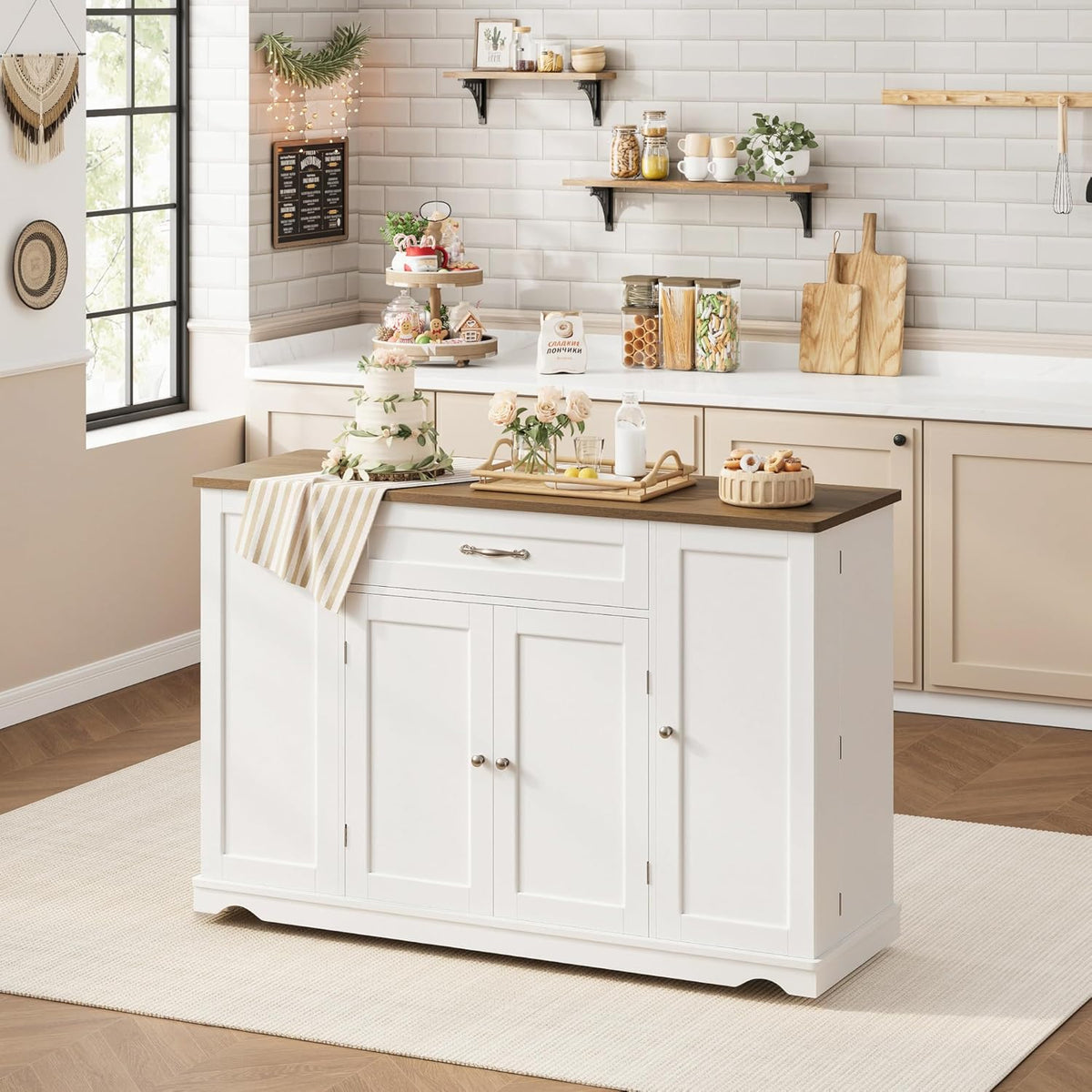 Angled view of white island with right-side door open revealing adjustable shelves and stored pantry items