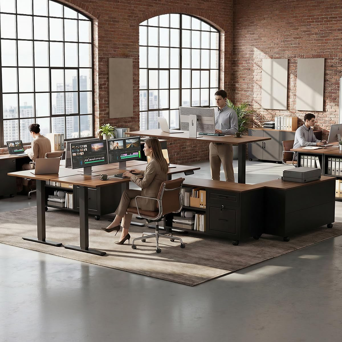 Open loft office with L-shaped walnut desks, black cabinet units, people working at sit-stand stations.