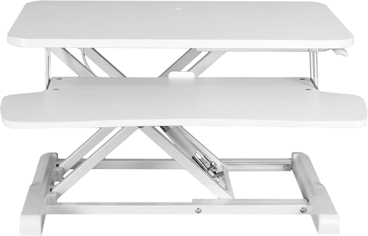 Front view of a white standing desk converter with two-tier platforms and scissor lift frame.