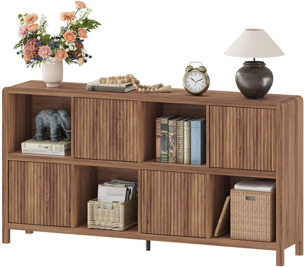 Walnut finish 8-cube bookcase with four fluted doors angled front view with lamp and vase on top