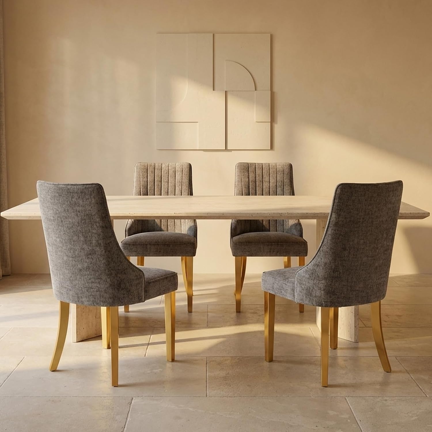 Side view of four light gray upholstered chairs with gold metal legs at a rectangular dining table.