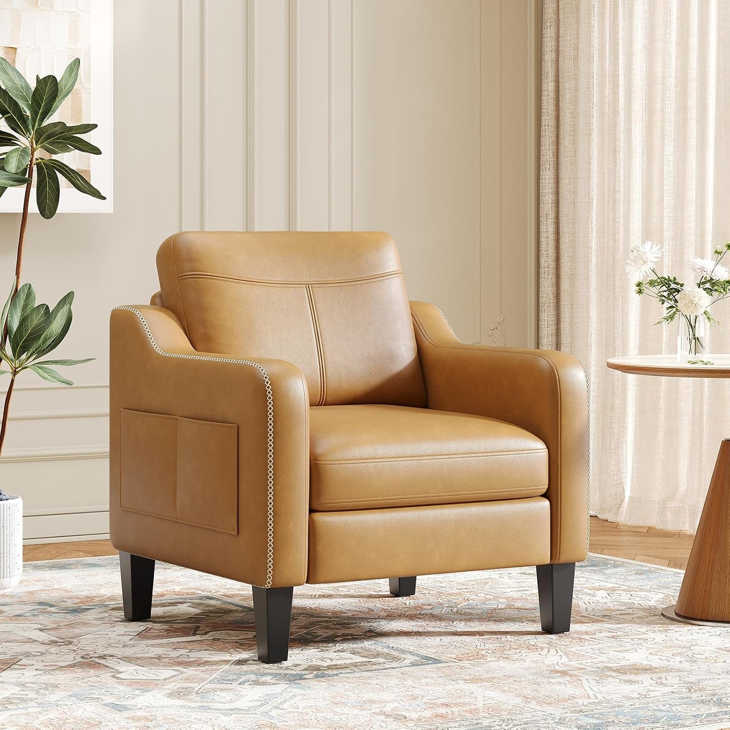 Tan leather-look mid-century armchair with black tapered legs in a living room setting