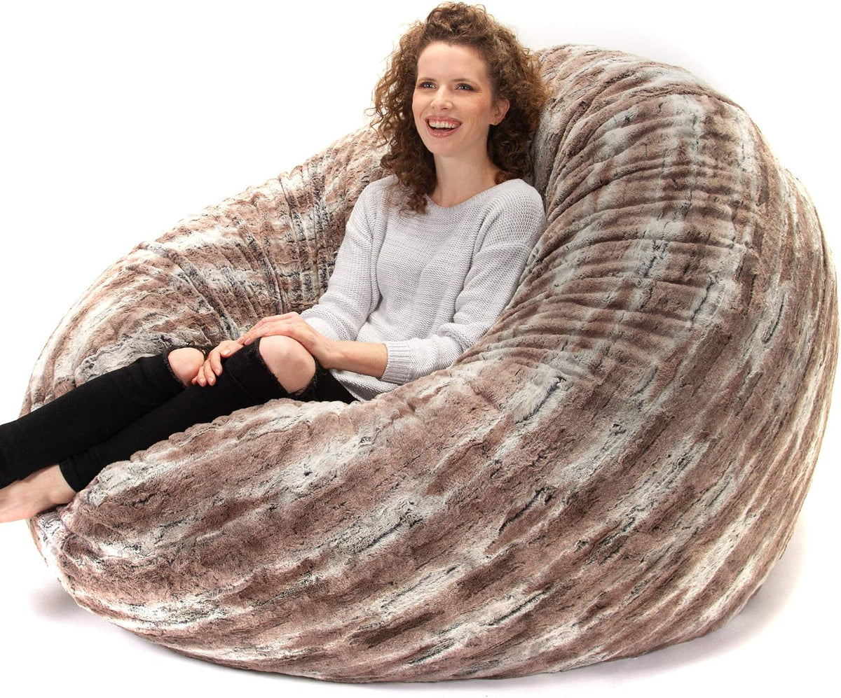 Textured taupe and gray patterned round bean bag with a seated woman smiling