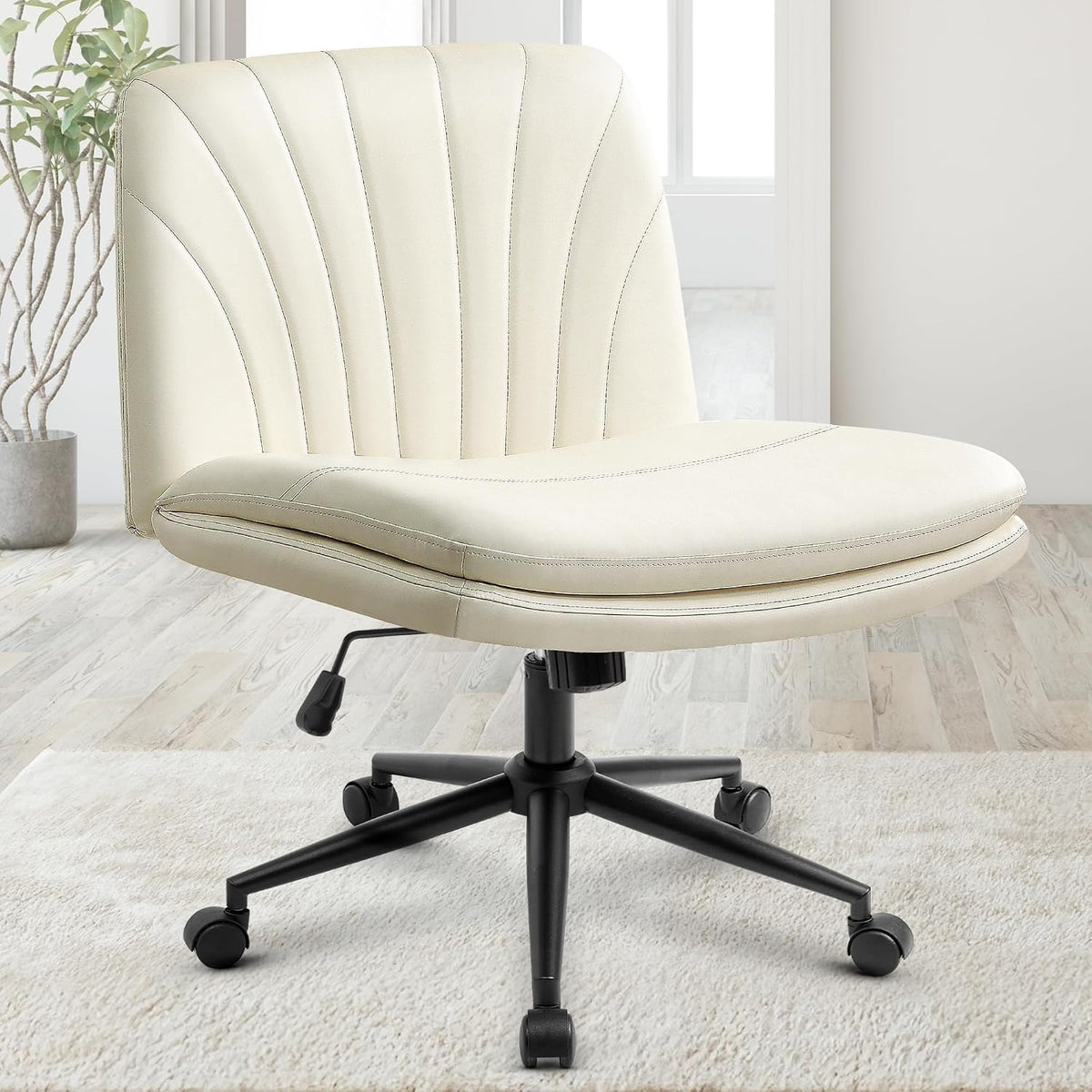 Close-up studio view of the beige padded chair with stitched back, black base and wheels on a pale rug.