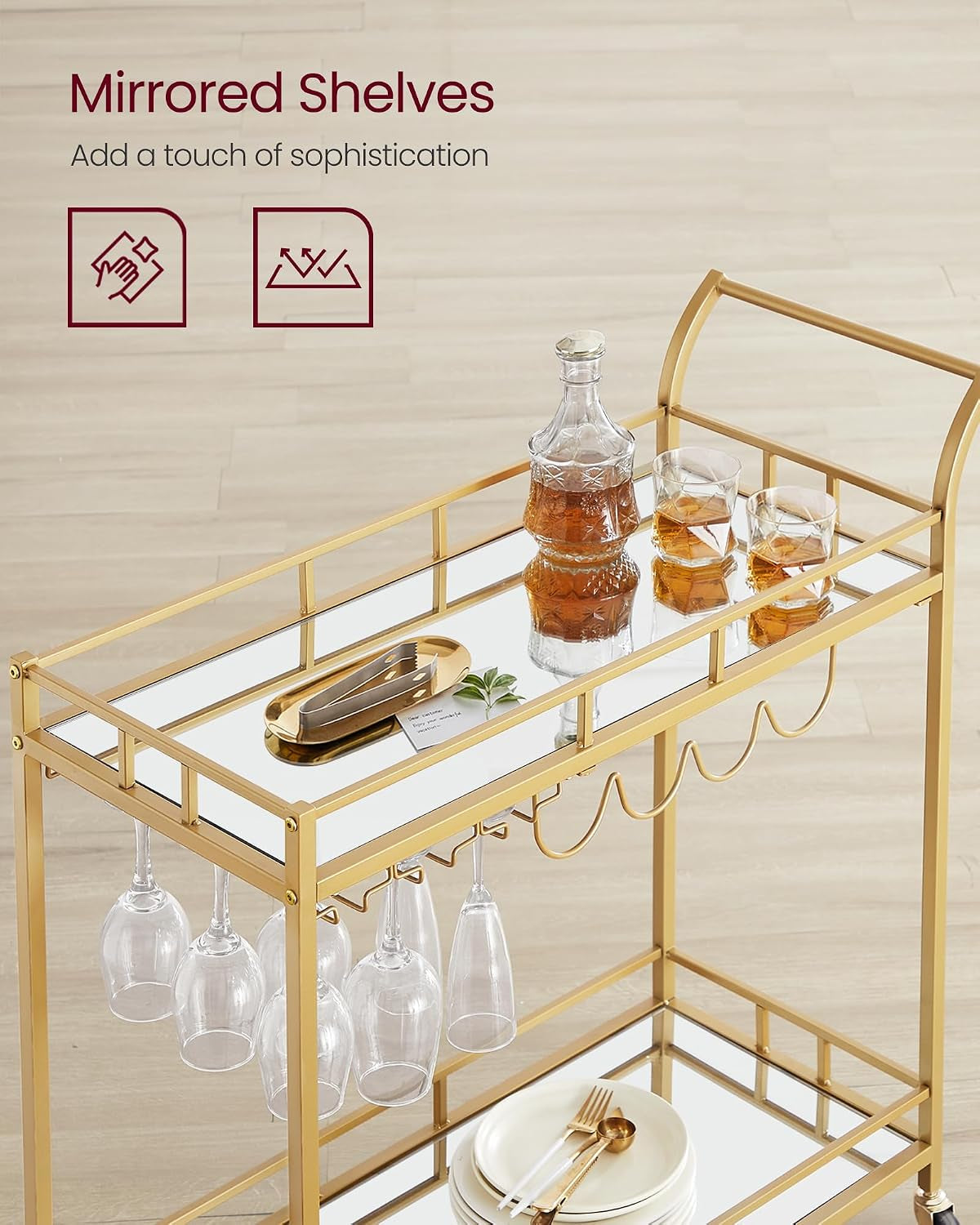 Close-up of top mirrored shelf with a glass decanter, two tumblers and wine glasses hanging underneath.