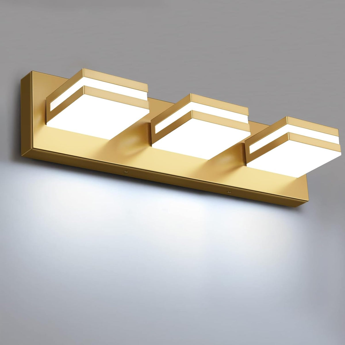 Close-up angled view of three gold square LED modules projecting from a rectangular gold backplate.