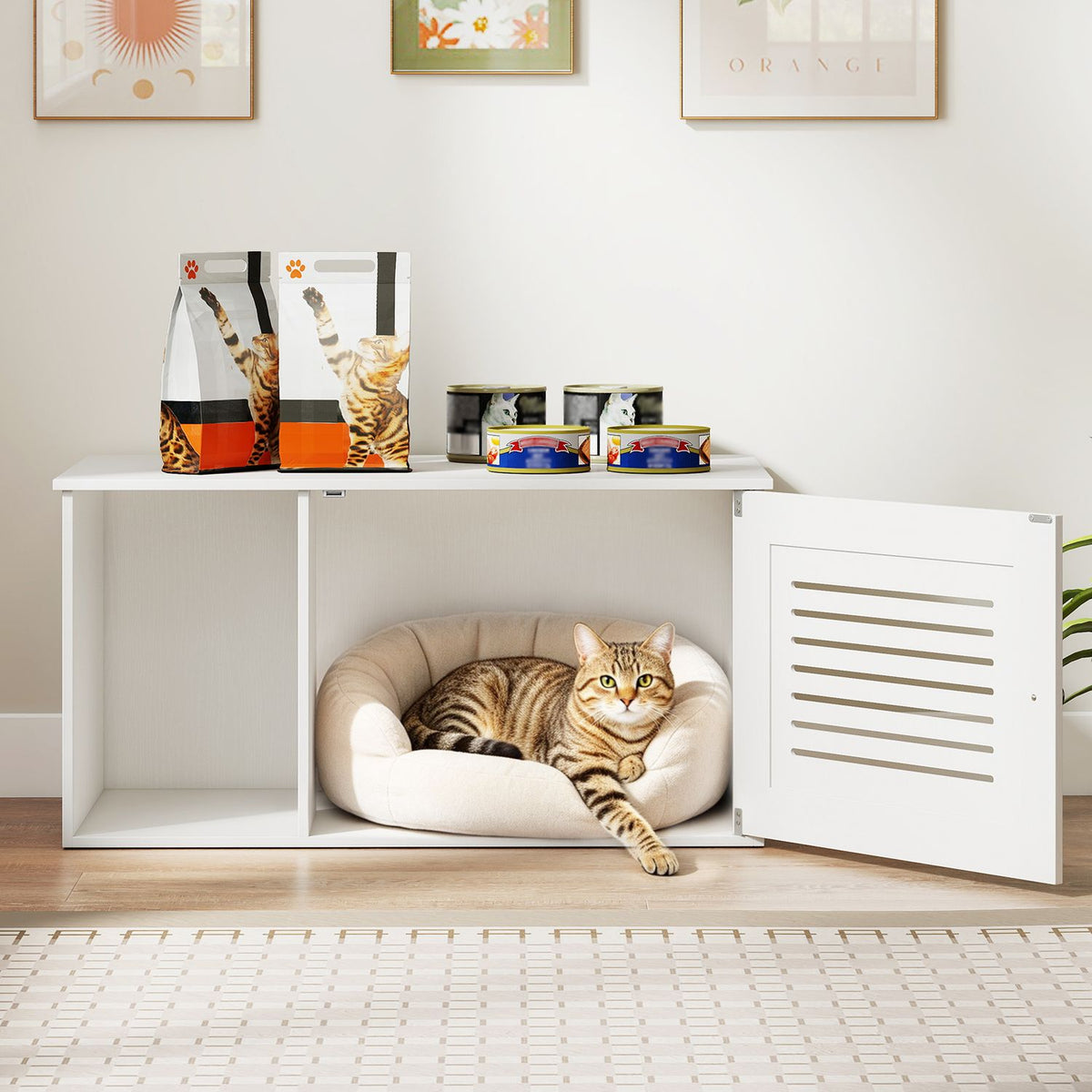 White litter box enclosure with its slatted door open, showing a tabby cat curled in a bed inside.