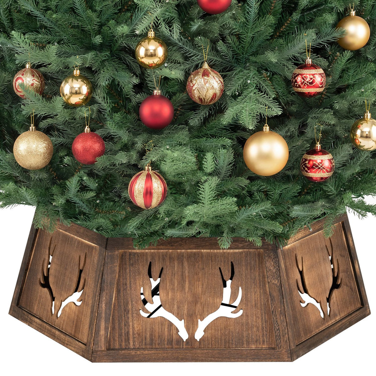 Rustic brown antler-cutout collar around the base of a green Christmas tree