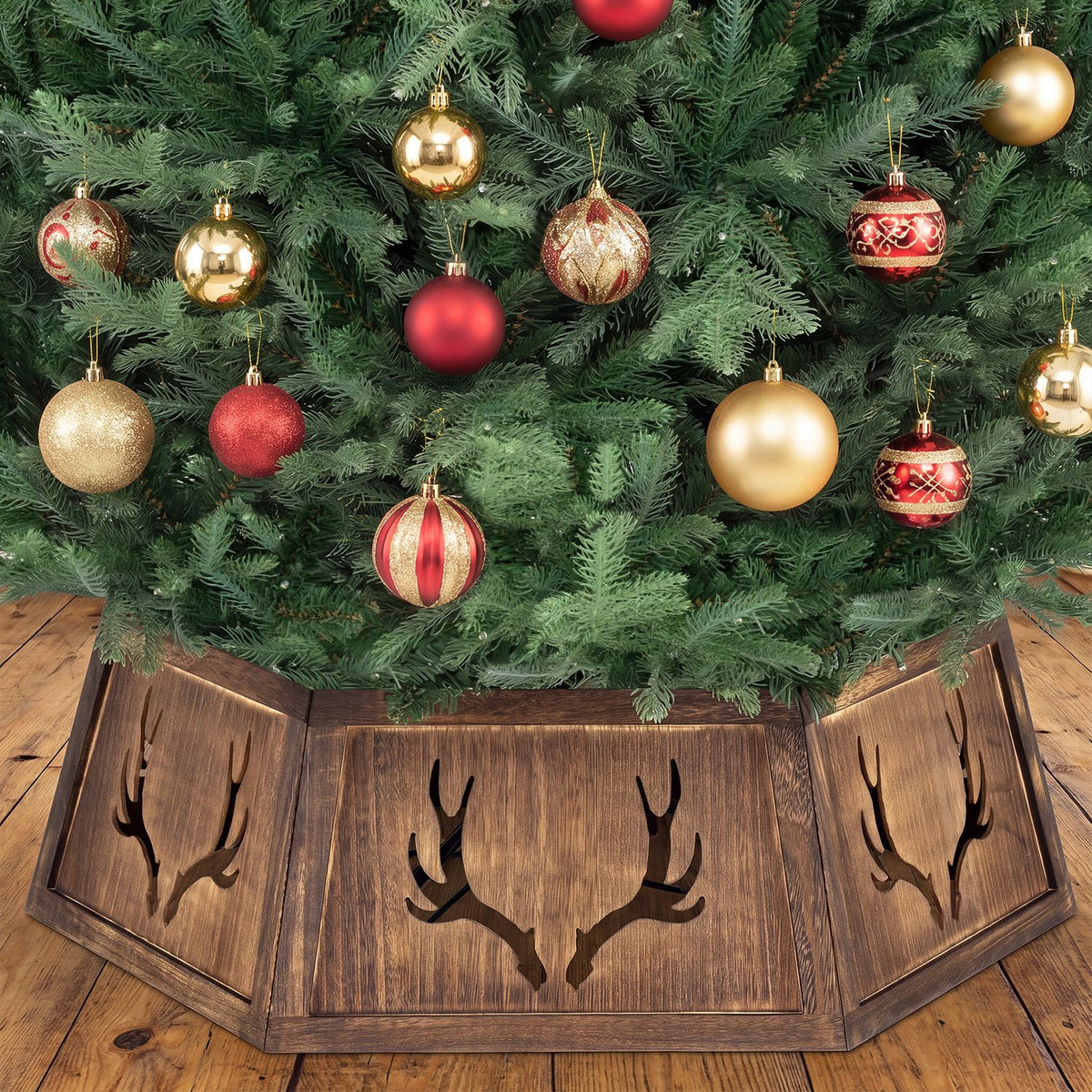 Close view of a rustic brown antler-cutout collar beneath a decorated tree
