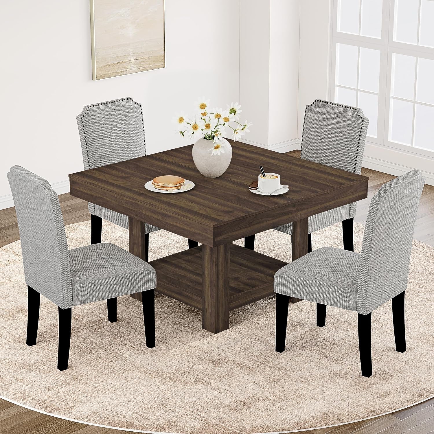 Dark walnut 47-inch square dining table shown with four upholstered chairs and place settings in a dining area
