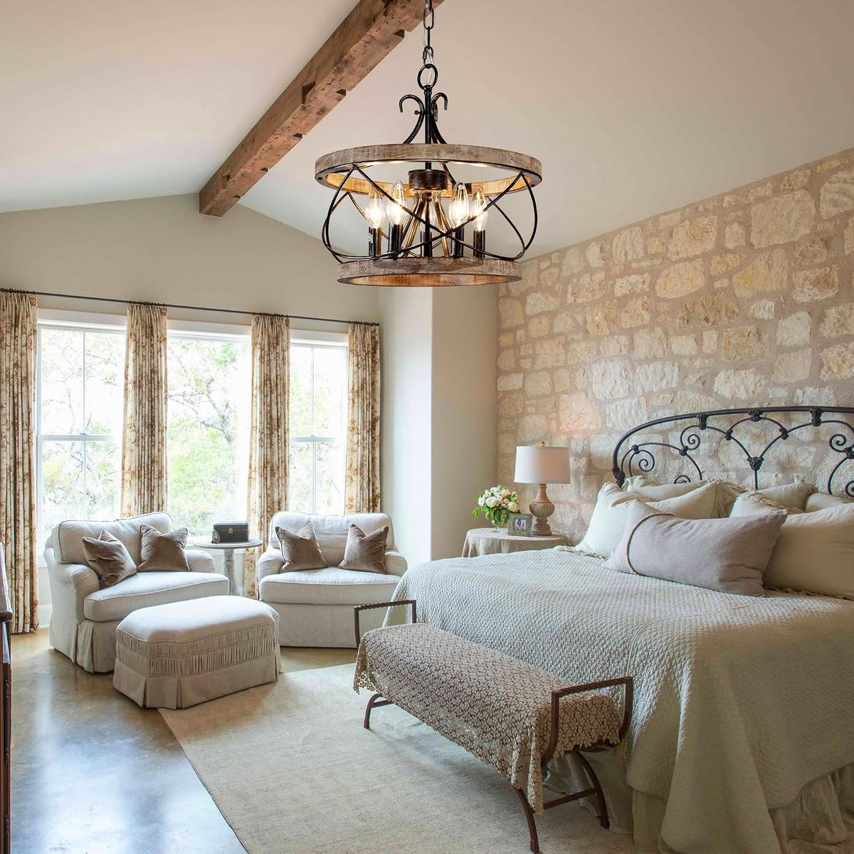 Single wood drum chandelier with black iron accents hanging from a vaulted ceiling in a bedroom setting