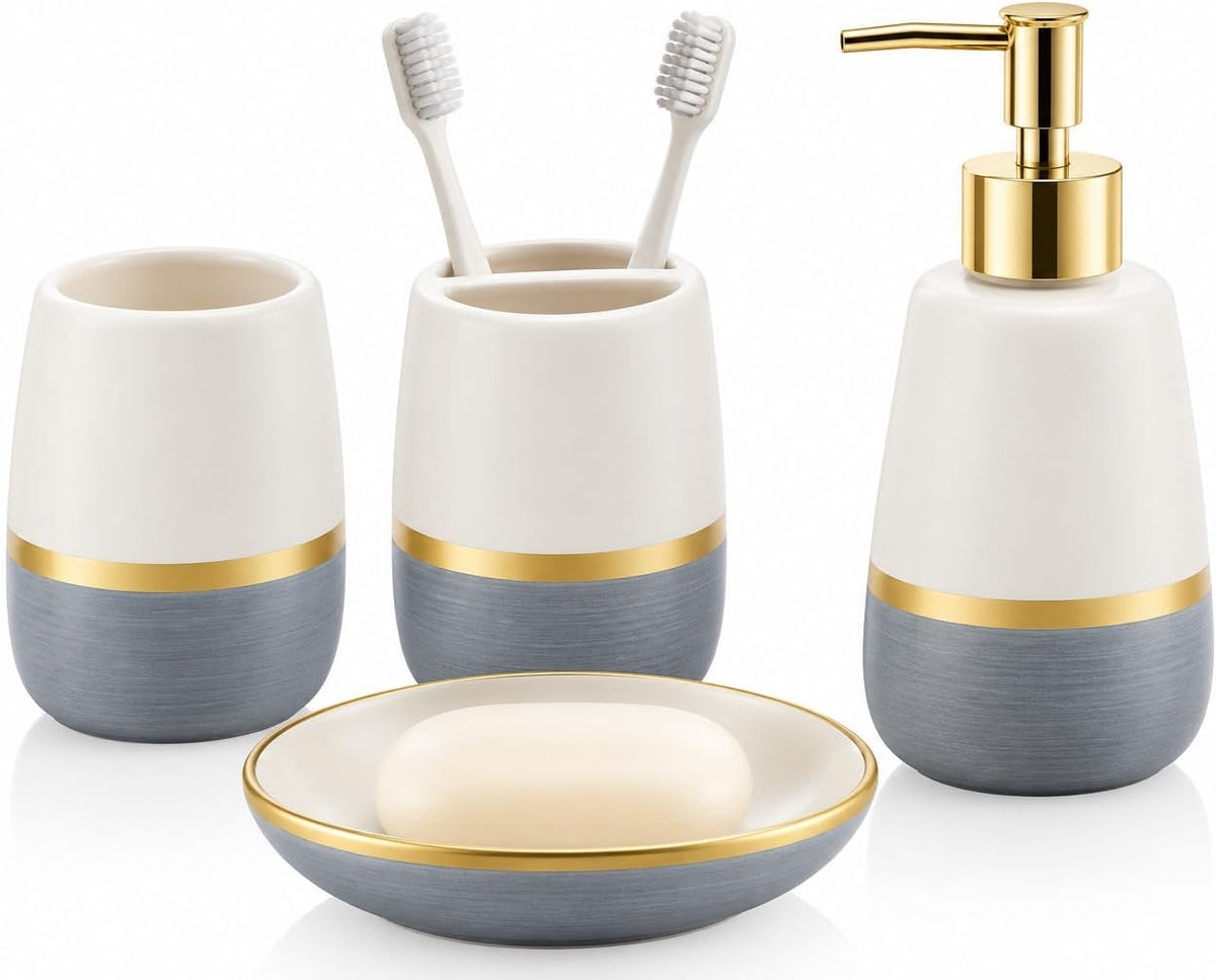 Set of four ceramic bathroom accessories with white tops, gray brushed bottoms and gold trim on white background