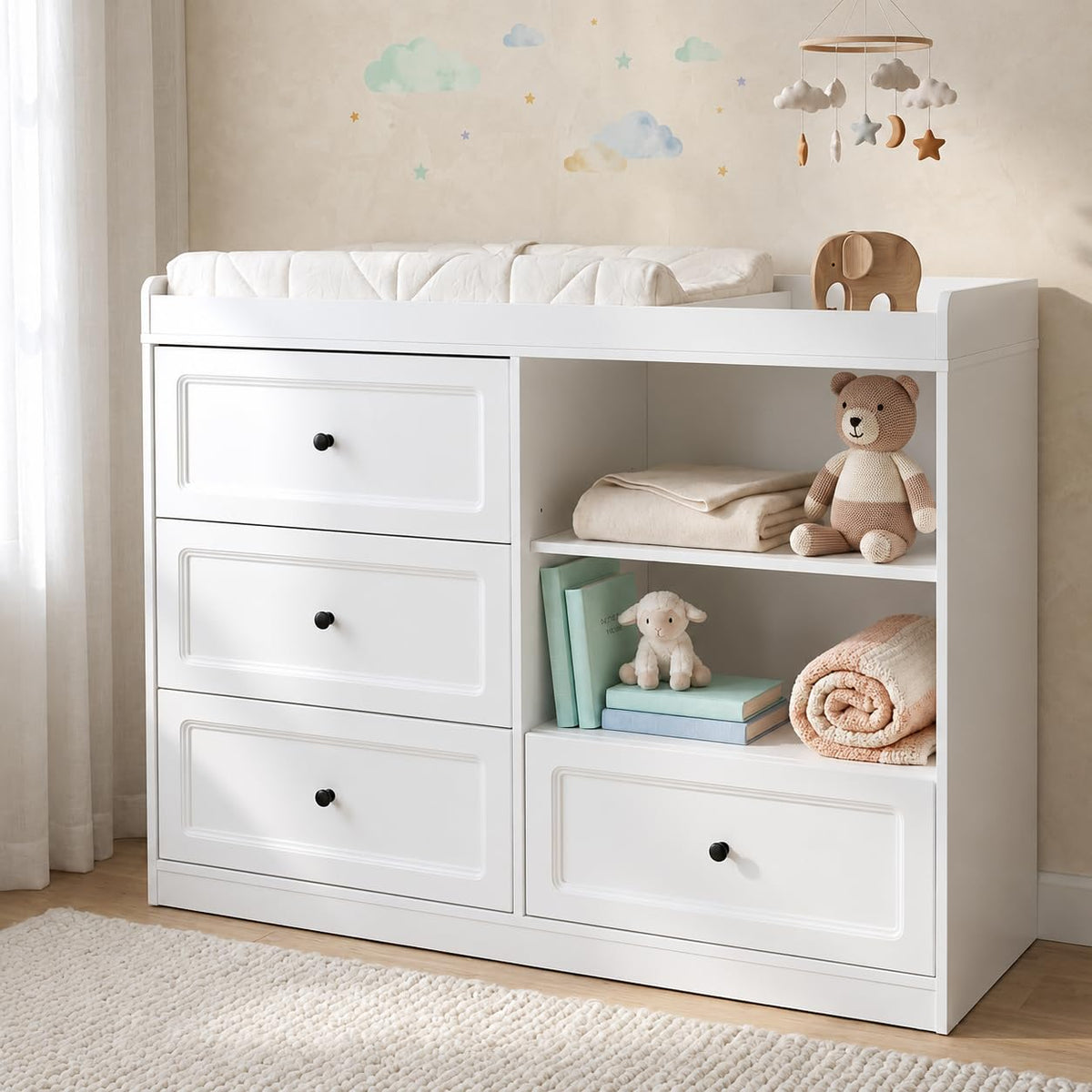 White changing dresser variant with black knob pulls, open shelves and decorative toys