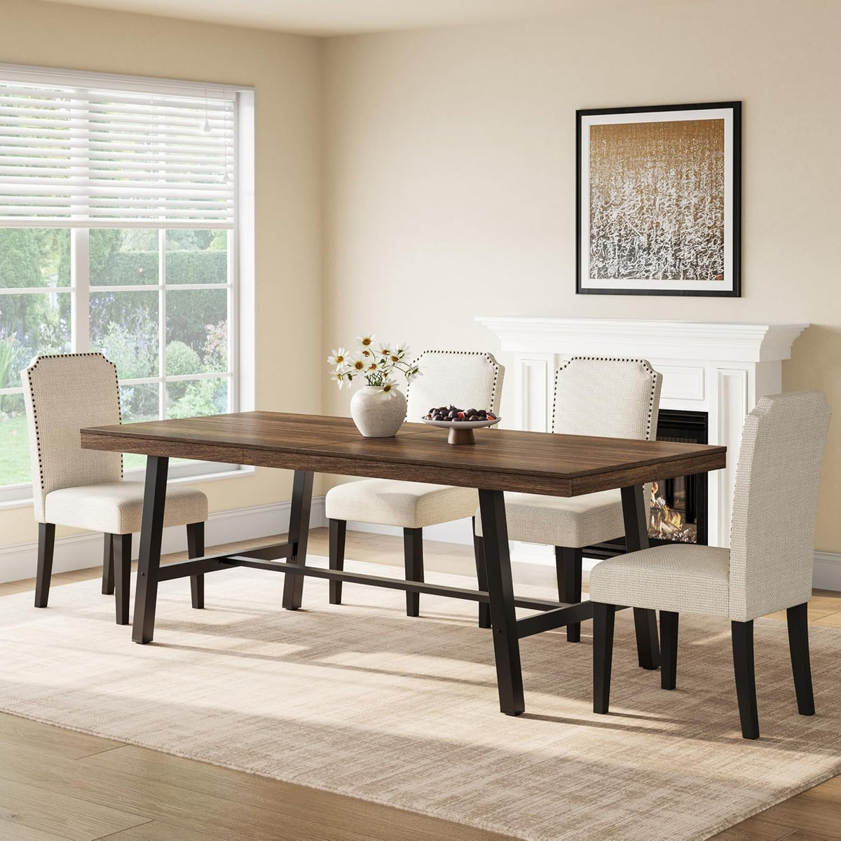 Angled view of a long brown wood dining table with crossbar supports and upholstered chairs on a neutral rug.