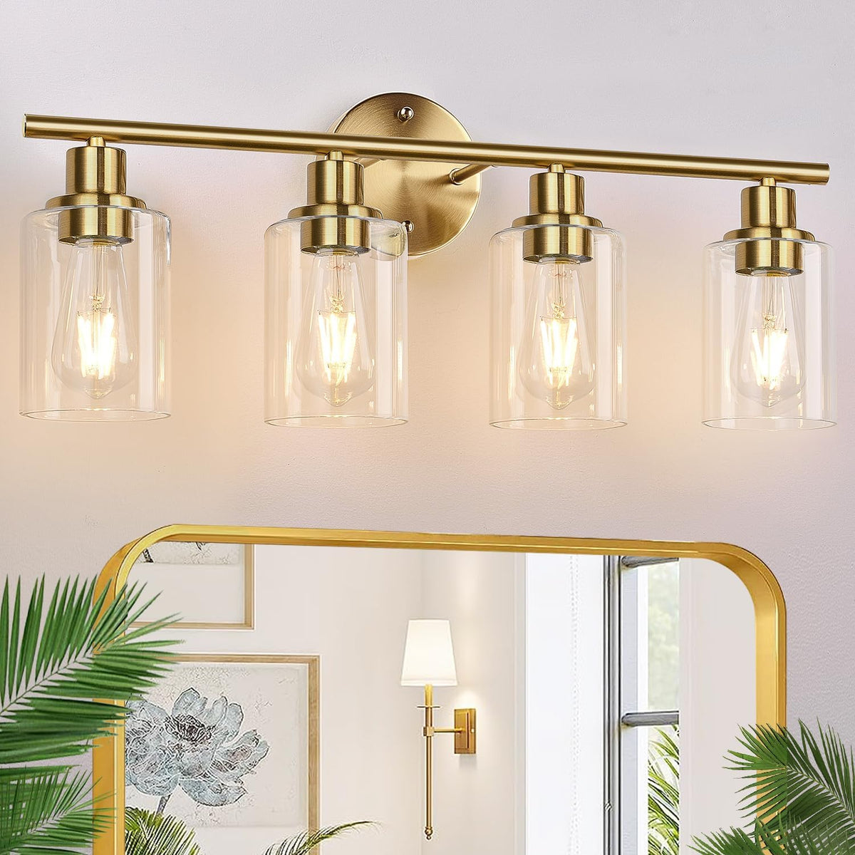 Four-light brass vanity fixture with clear glass shades mounted above a mirror in a bathroom scene.