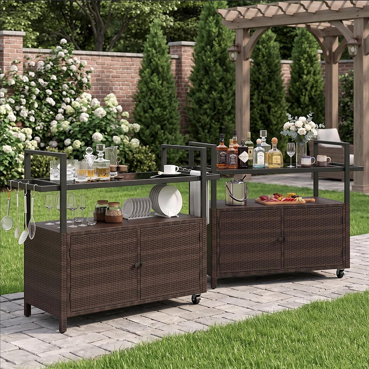 Two dark-brown rattan bar carts arranged outdoors on a paved path with pergola and garden backdrop.