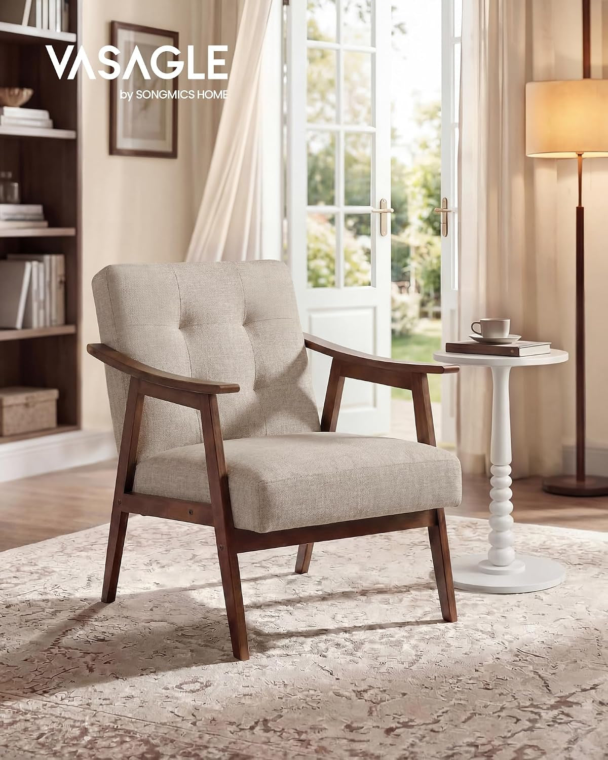 Beige tufted lounge chair beside a small white side table and floor lamp in a bright room with open French doors.