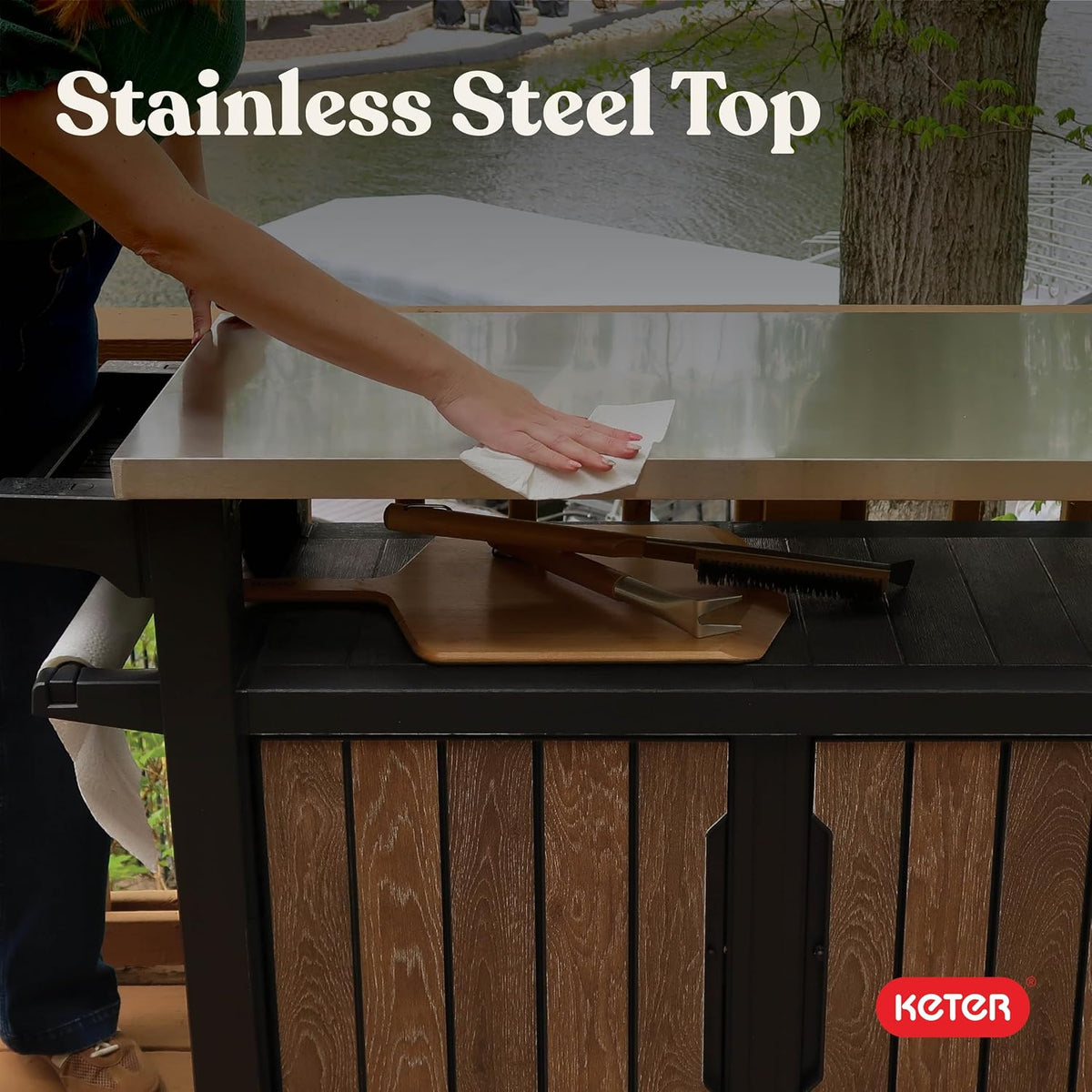 Close-up of the stainless-steel countertop being wiped with the storage shelf visible beneath