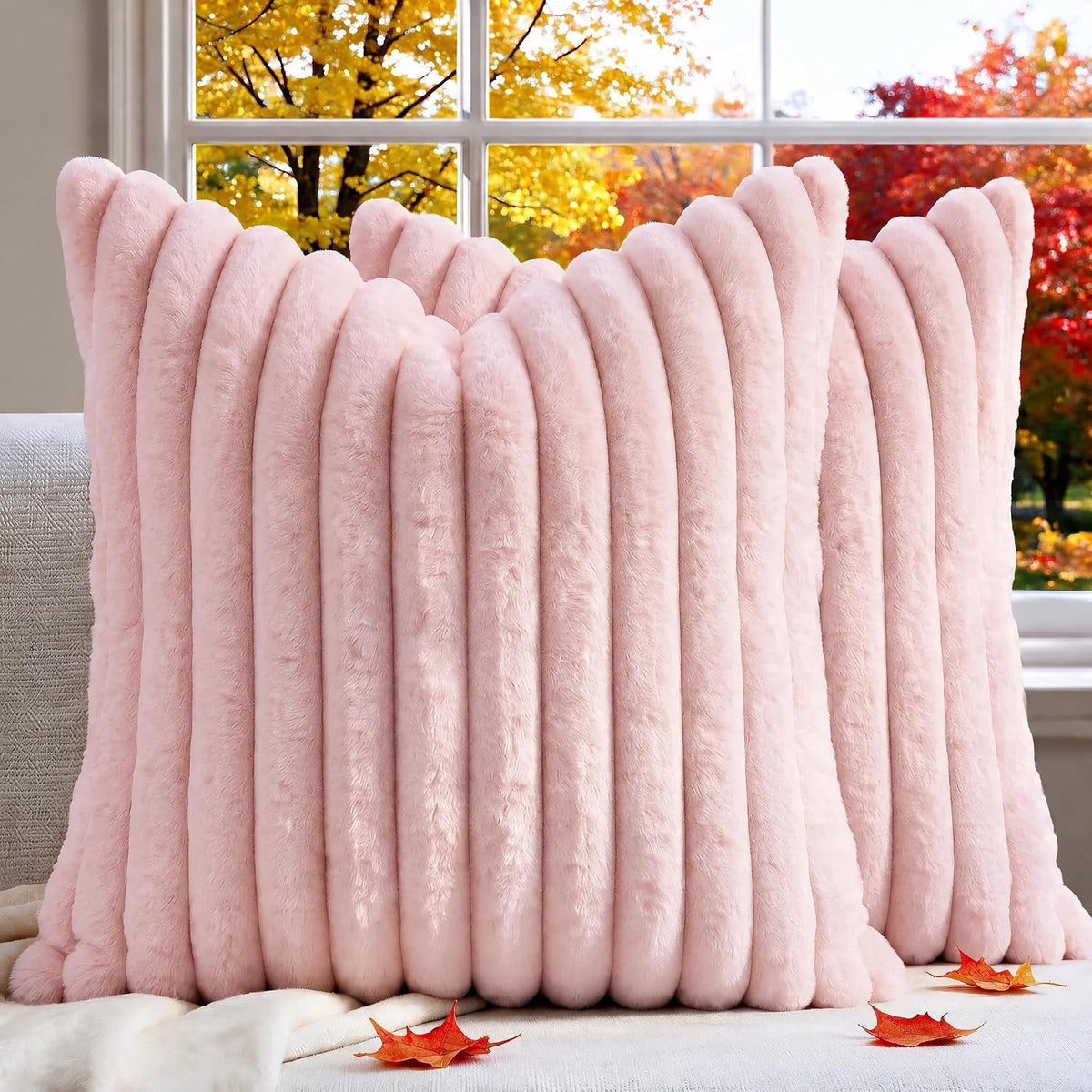 Close-up of a pale pink ribbed faux-fur pillow cover showing soft vertical tube-like texture.