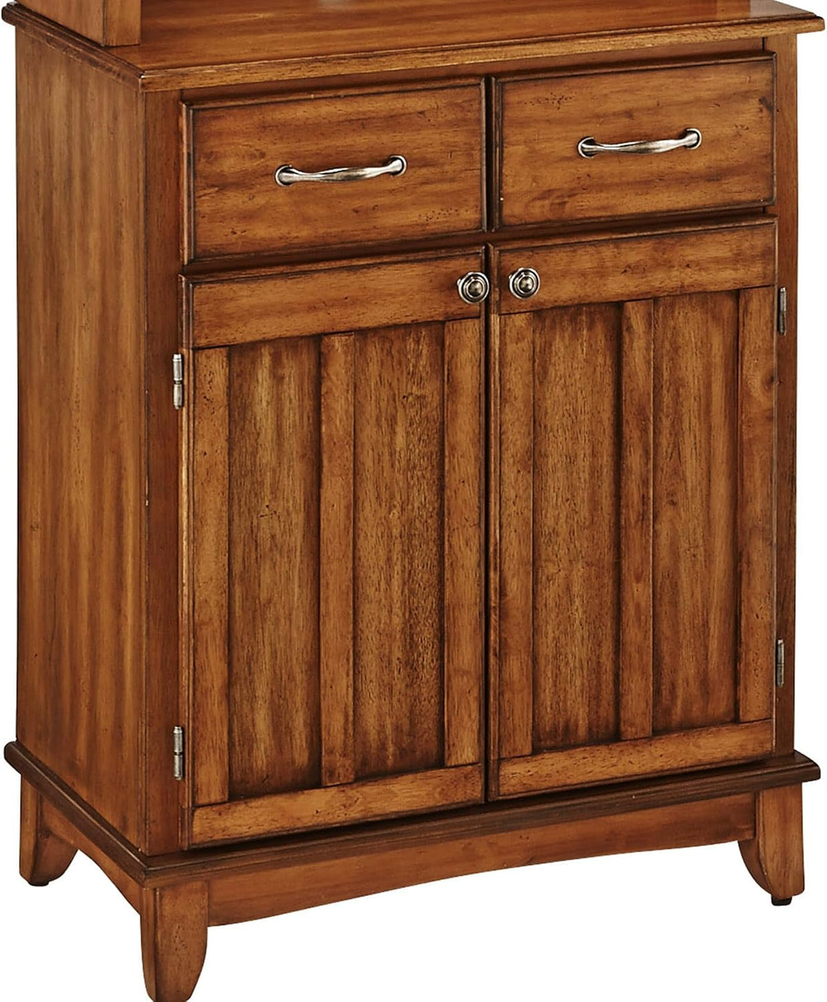 Close-up of lower base showing two drawers, vertical-paneled cabinet doors and brushed steel handles