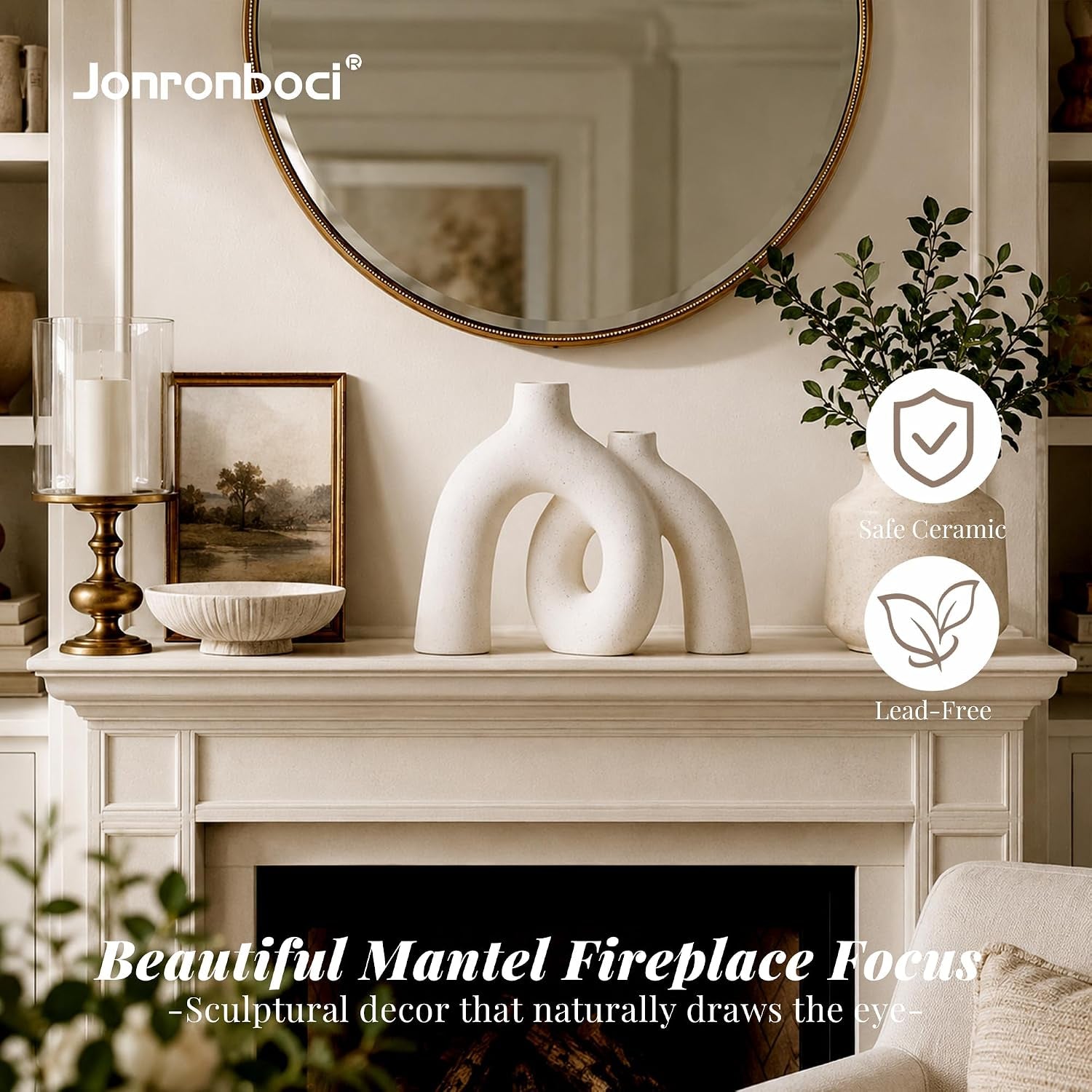 Cream ceramic donut vase displayed on a mantel under a round mirror with greenery and framed art surrounding it