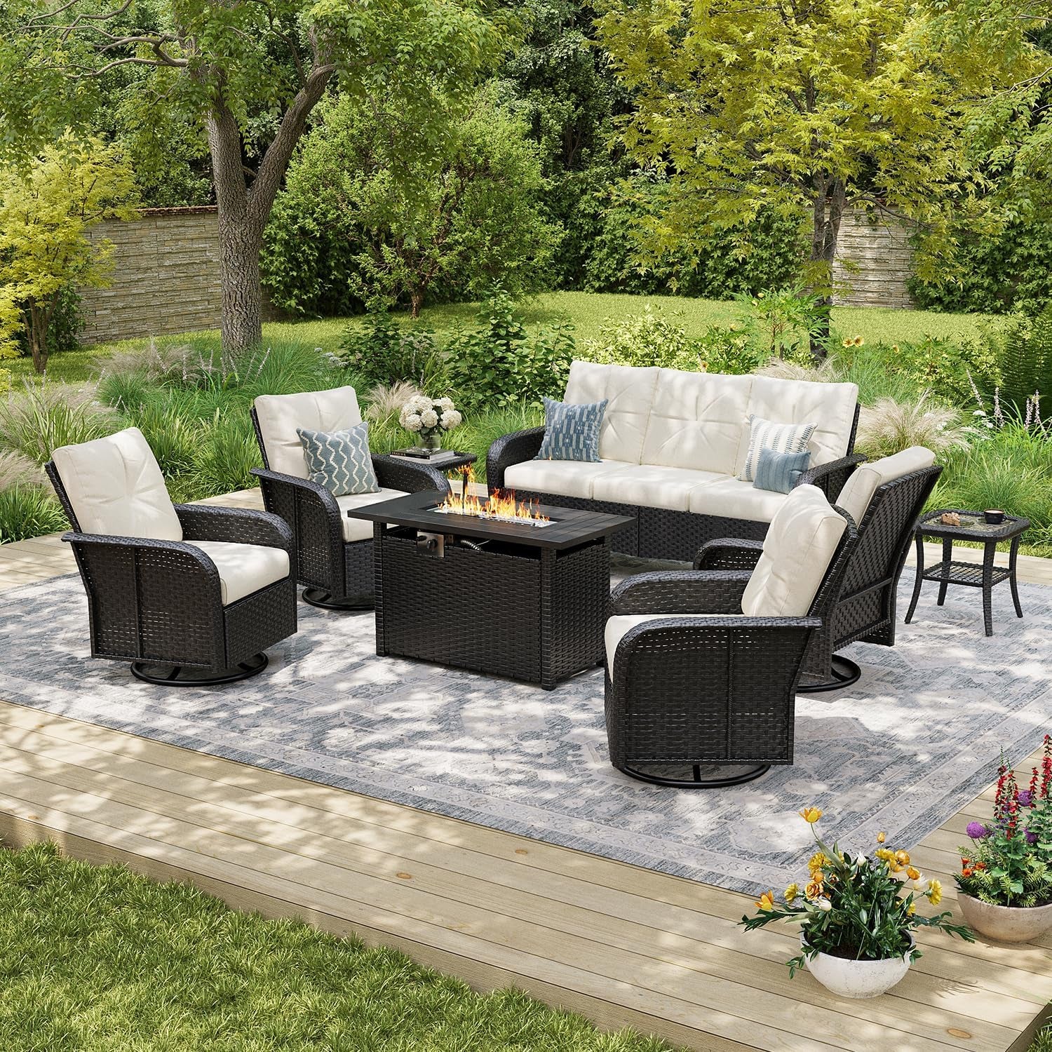 Outdoor seating group with cream cushions, dark wicker frames and a rectangular fire pit table on a deck rug