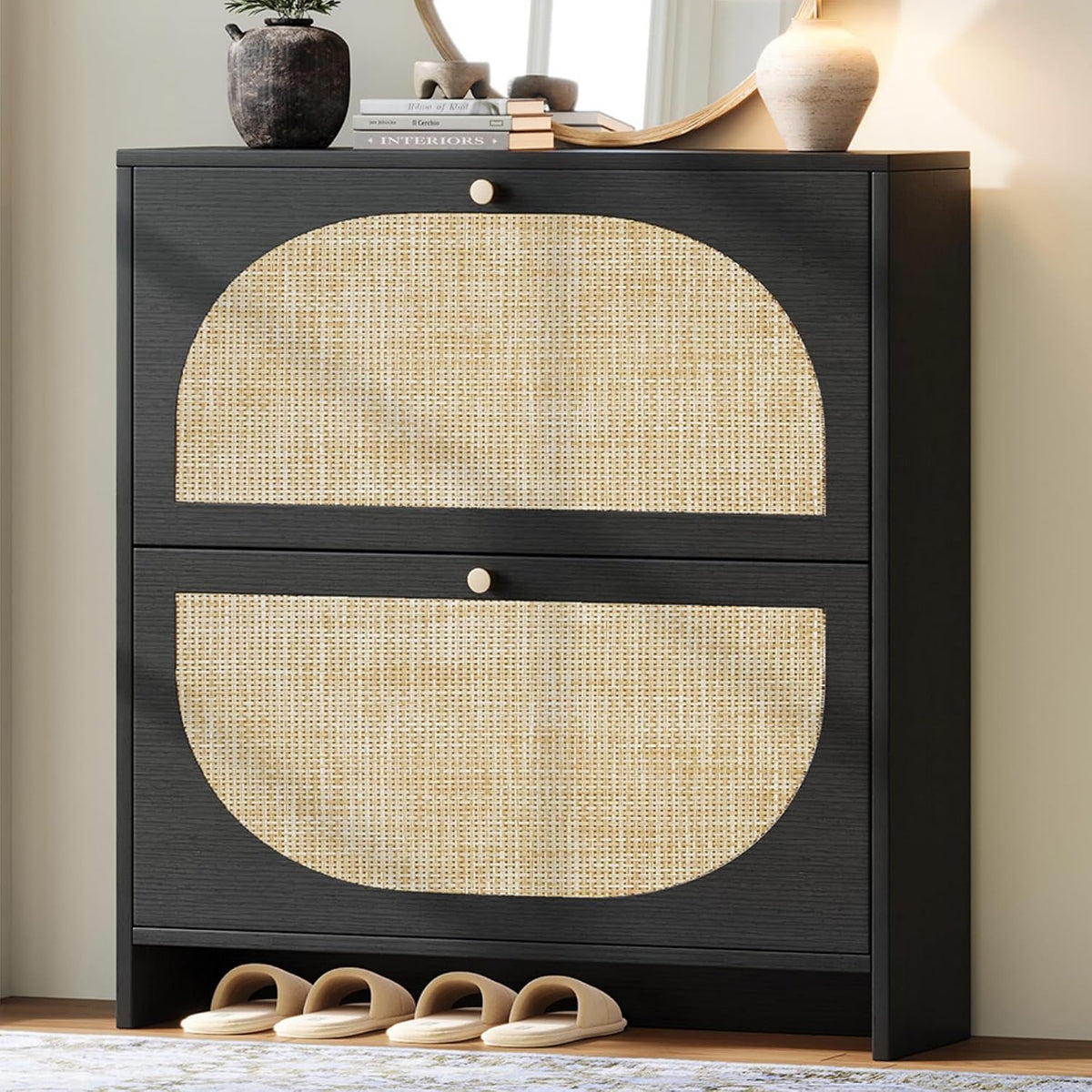 Black shoe cabinet showing two wide flip drawers with semi-circular cane insets and slippers lined beneath