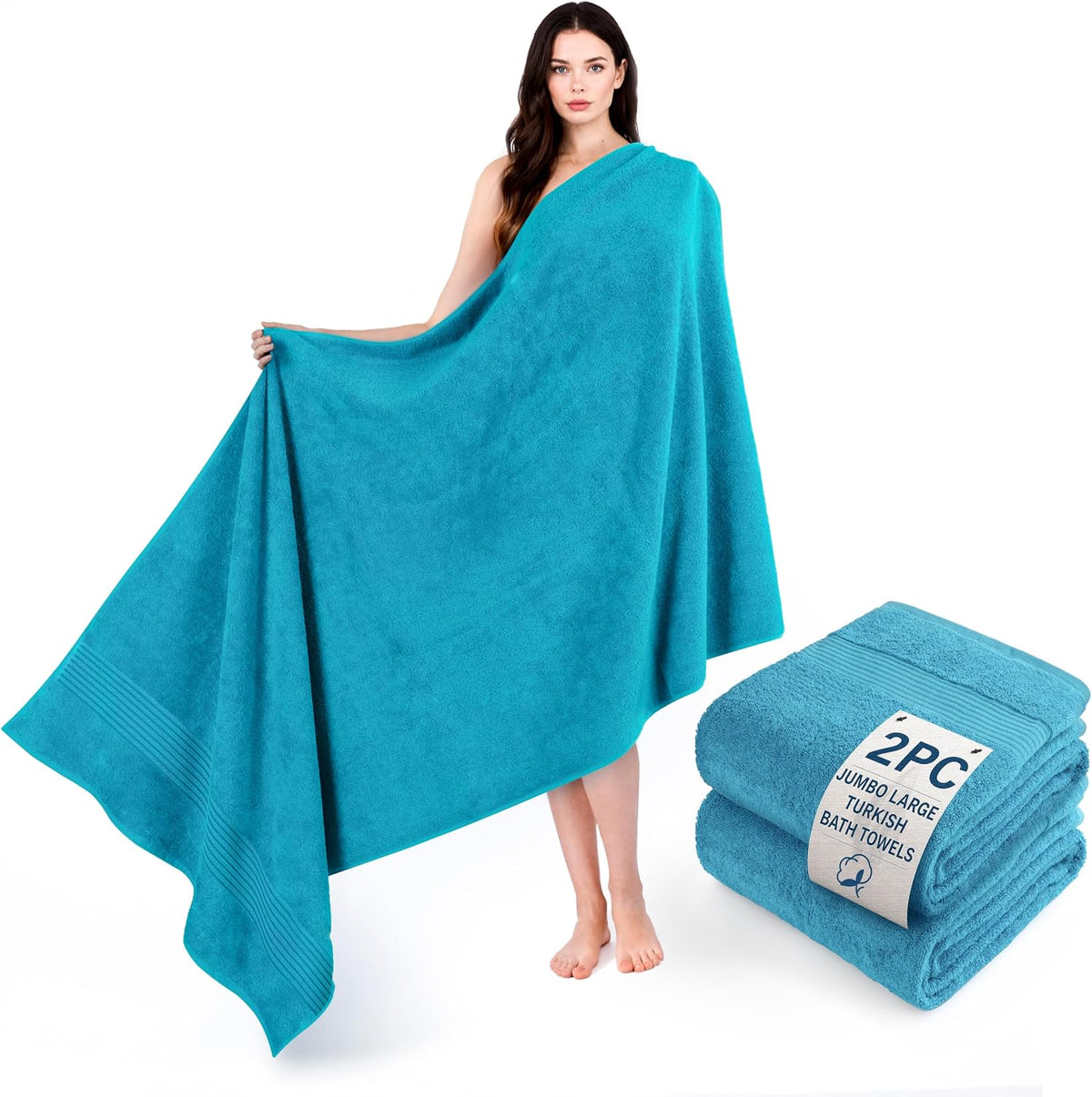 Model draped in a large bright turquoise towel standing beside a small folded towel stack.