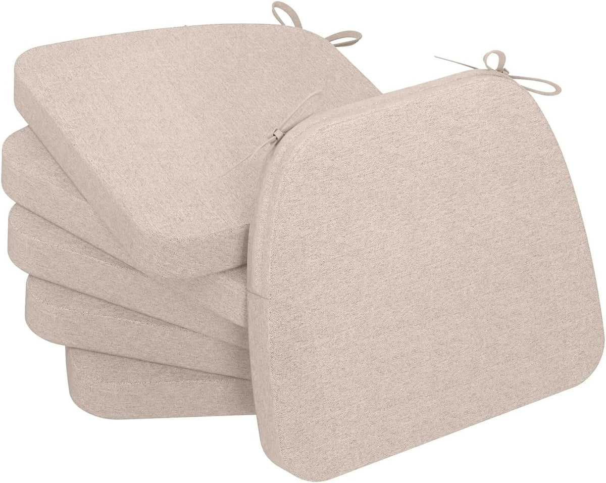 Stack of four oatmeal beige D-shaped chair cushions with visible ties and removable covers.