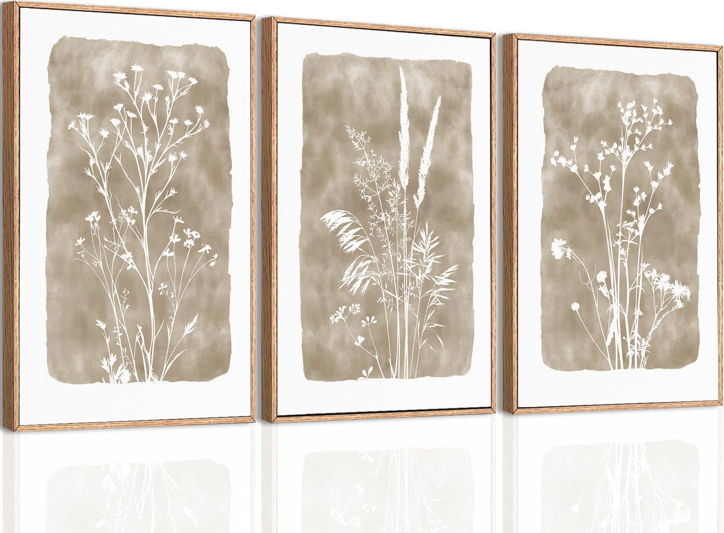 Three vertical framed prints showing white wildflower silhouettes on tan watercolor washes with wood frames.
