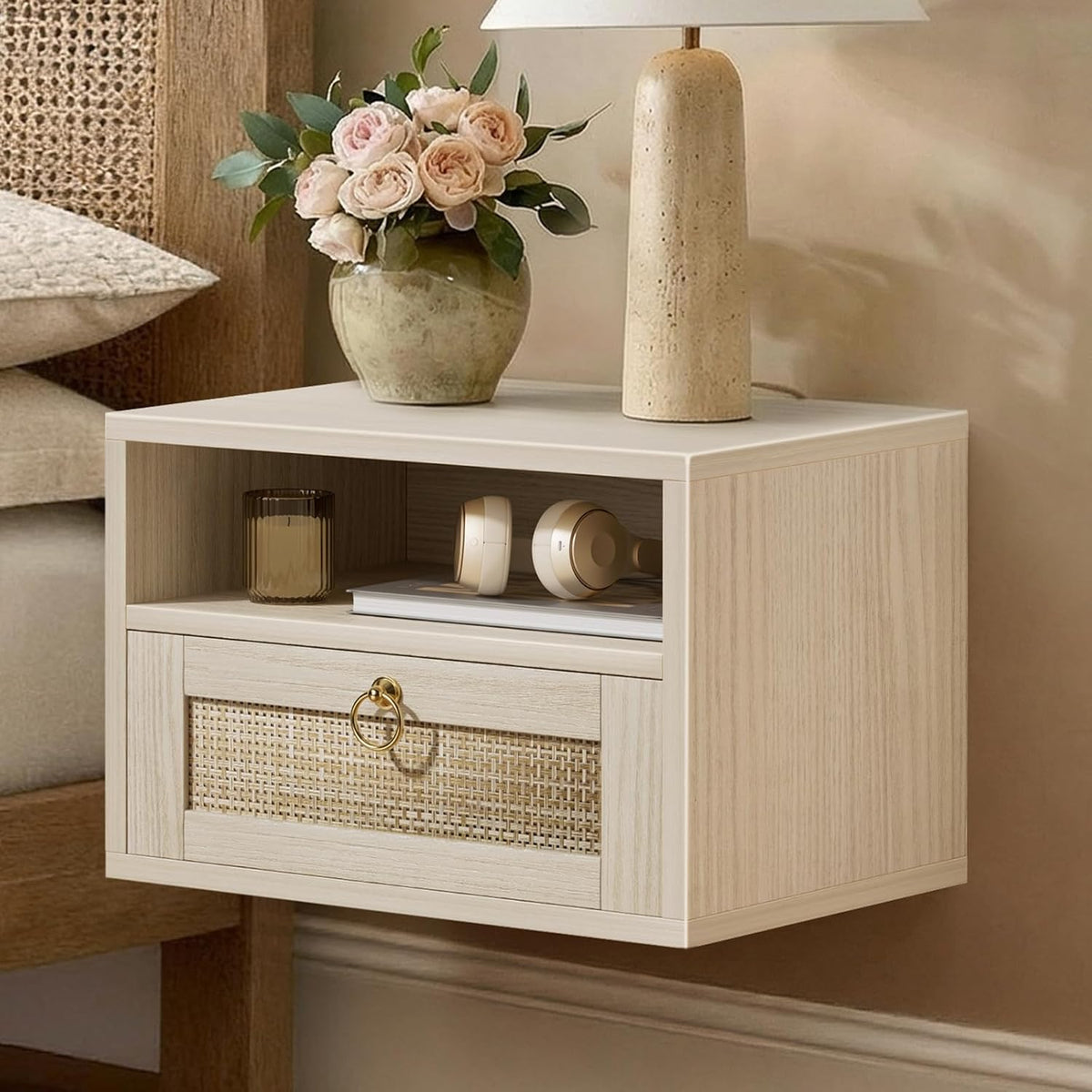Light oak floating nightstand angled front view showing rattan-front drawer and open cubby with lamp and vase