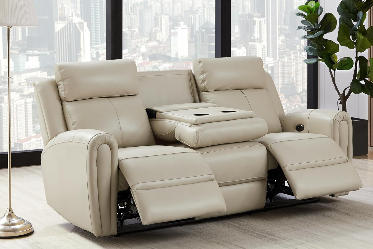 Cream leather reclining sofa with center cup-holding console open and both footrests extended.