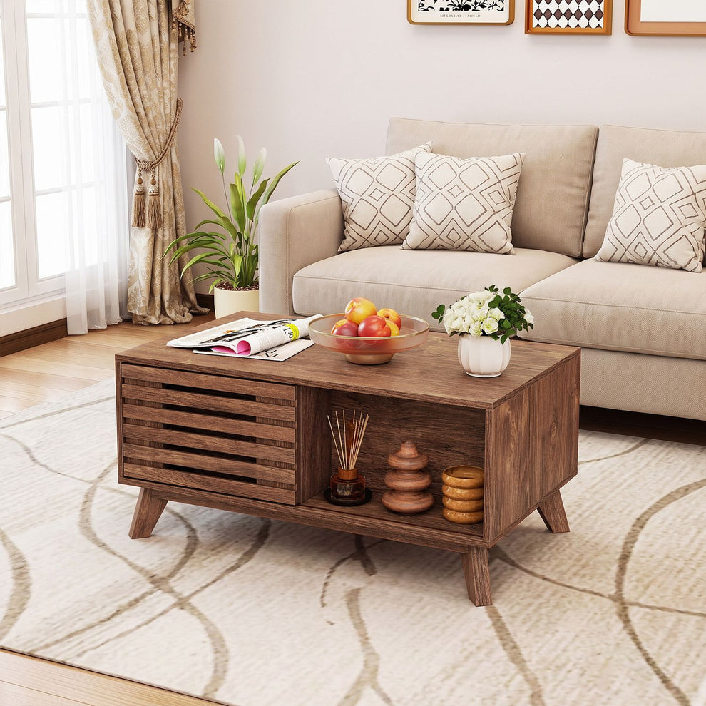 Brown coffee table with a slatted front and open display cubby in a bright living room.