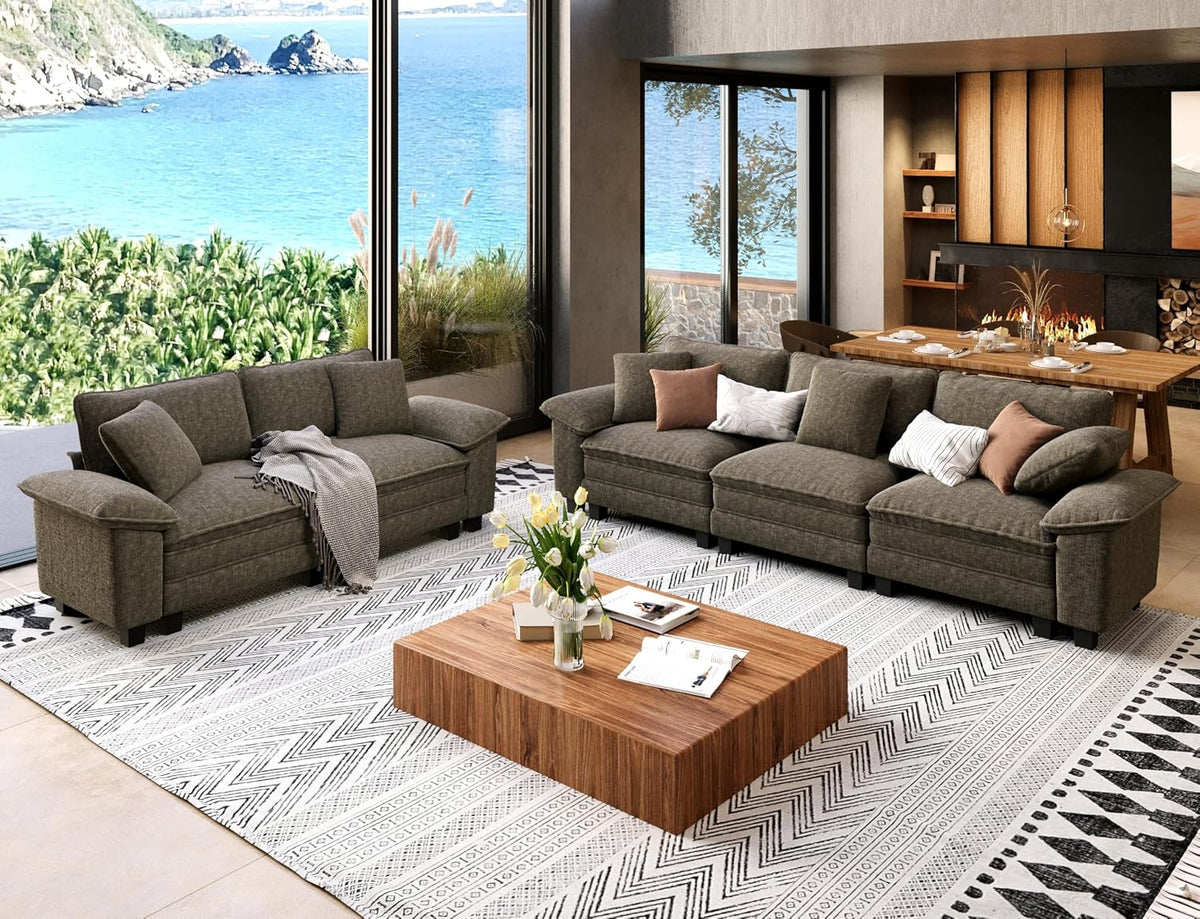 Living room with a dark olive two-piece sofa set, wooden coffee table and ocean view through floor-to-ceiling windows.